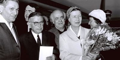 Simone de Beauvoir, left with flowers