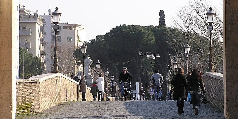 People strolling on the Milvian Bridge in Rome