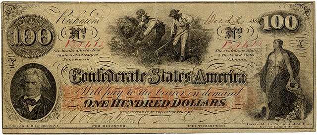 A One Hundred Dollar Confederate States of America banknote dated December 22, 1862. Issued during the American Civil War (1861–1865). Slave hoeing cotton in the center with John C. Calhoun on the left and Columbia on the right. Over 670,000 of these notes were issued from August, 1862 to January, 1863.