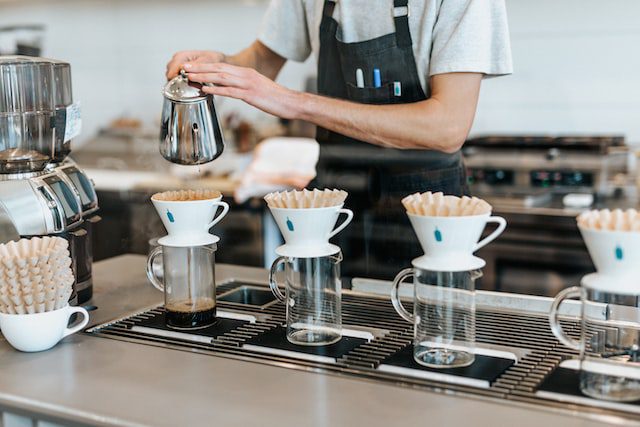 Man pouring coffee into cups