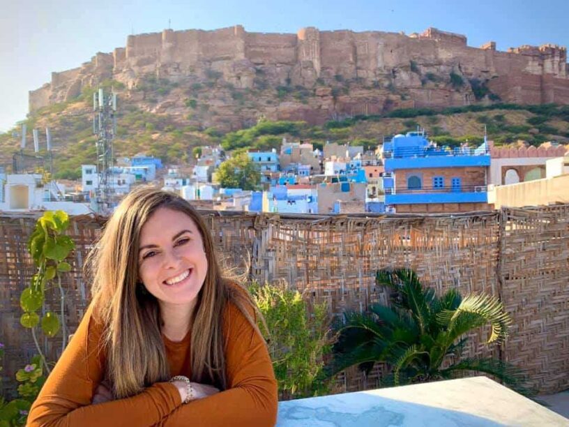 Lauren of Never Ending Footsteps smiling in front of Mehrangarh Fort in Jodhpur