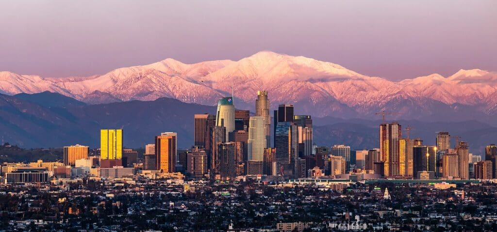 February shot of downtown Los Angeles sunset with Mount Baldy in the background after a large snow storm.