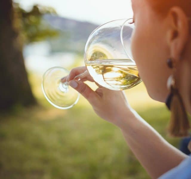 A lady drinking wine