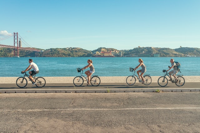 A group of people cycling by Helio Dilolwa -Unsplash