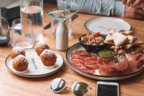 A meal of tapas, meats, pasta and pizza by Maddi Bazzocco - Unsplash