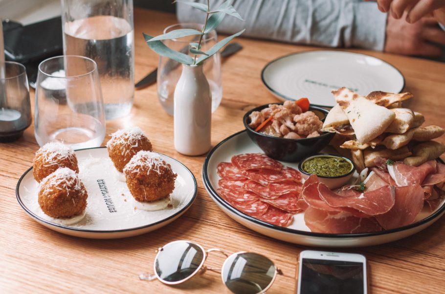 A meal of tapas, meats, pasta and pizza by Maddi Bazzocco - Unsplash