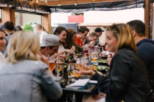 People eating a meal around a table by Priscilla Du Preez - Unsplash
